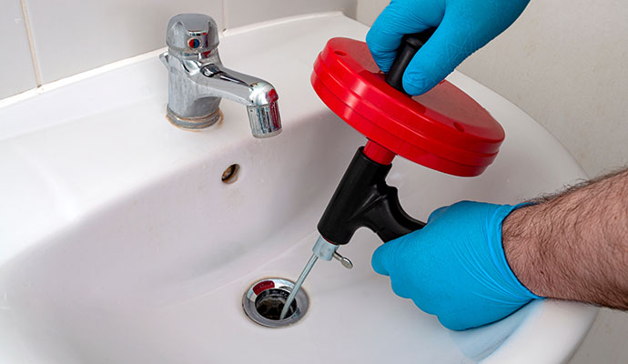 Drain cleaning service A professional cleaning sink drain using drain sink