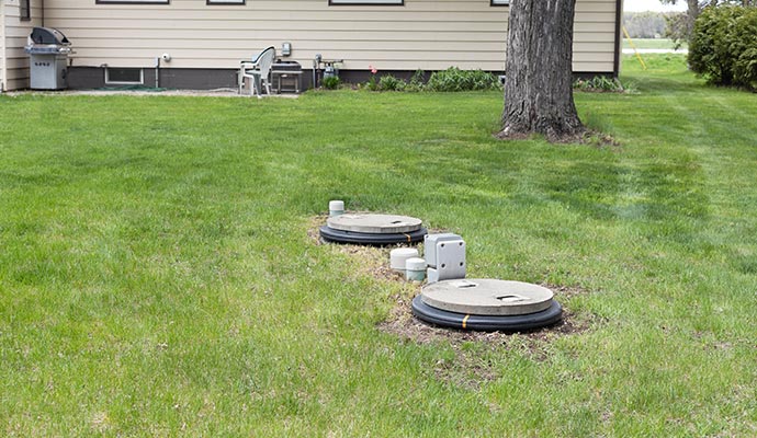 Residential septic tank access points installed in yard Residential septic tank access points installed in a yard